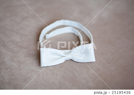 White wedding bow tie on gray background White wedding bow tie on gray background 25195436