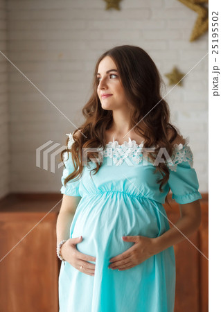 Pregnant woman touching her belly with hands Pregnant woman touching her belly with hands 25195502
