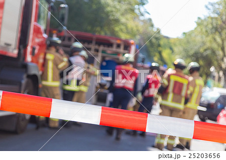 Team of firefighters by firetruck on accident 25203656