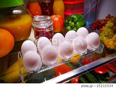 Chicken eggs on a shelf open refrigerator Chicken eggs on a shelf open refrigerator 25215534