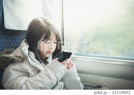 Little asian girl sharing social media in a smart phone Little asian girl sharing social media in a smart phone 25219002