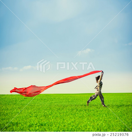 Beautiful young woman jumping on a green meadow Beautiful young woman jumping on a green meadow 25219376