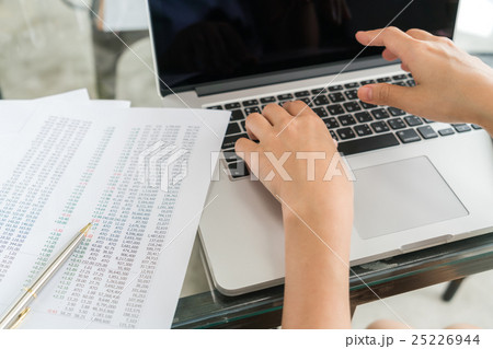 Business woman hand with Financial charts and laptop on the table . 25226944