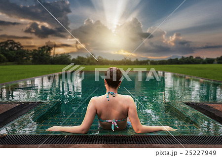 Woman sitting in swimming pool Woman sitting in swimming pool 25227949
