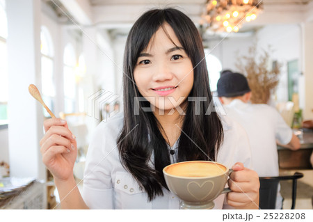 Asian young woman hold coffee cup 25228208