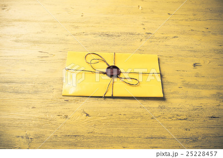 Letter with seal on table 25228457