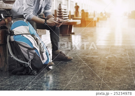A man sit with map. travel bag at train station. 25234978