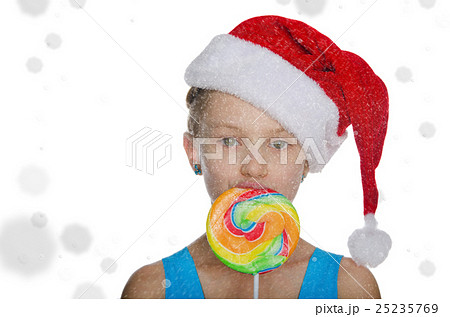 girl in Santa hat with candy of falling snow girl in Santa hat with candy of falling snow 25235769