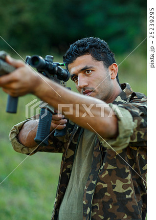 Man of Arab nationality in camouflage with a gun Man of Arab nationality in camouflage with a gun 25239295