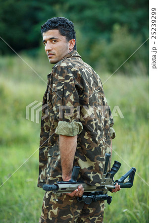 Man of Arab nationality in camouflage with a shotgun 25239299