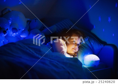 Little girl in bed with night lamp Little girl in bed with night lamp 25240620