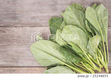 Green fresh Gai lan (Chinese broccoli) on wooden plank Green fresh Gai lan (Chinese broccoli) on wooden plank 25248655