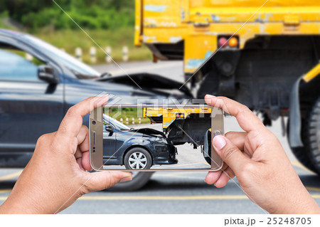 Hand of woman holding smartphone and take photo of car accident Hand of woman holding smartphone and take photo of car accident 25248705
