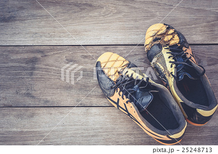 Old football shoes on grey wooden plank Old football shoes on grey wooden plank 25248713