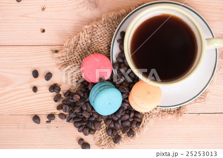 black coffee and macarons on wood table. 25253013