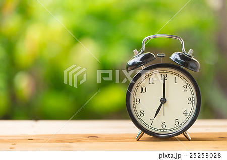 retro clock in green garden at 7 o'clock retro clock in green garden at 7 o'clock 25253028