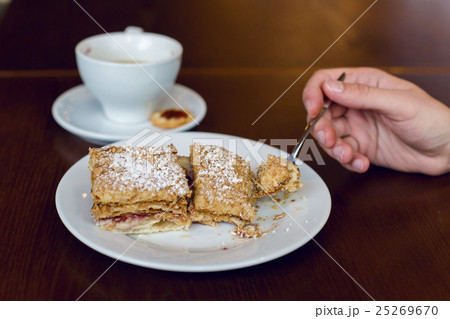 two dessert standing the hand with the spoon 25269670
