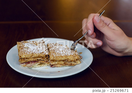 two dessert standing the hand with the spoon 25269671