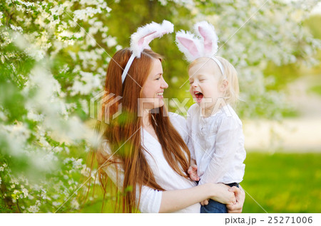 Young mother and her daughter wearing bunny ears on Easter day Young mother and her daughter wearing bunny ears on Easter day 25271006