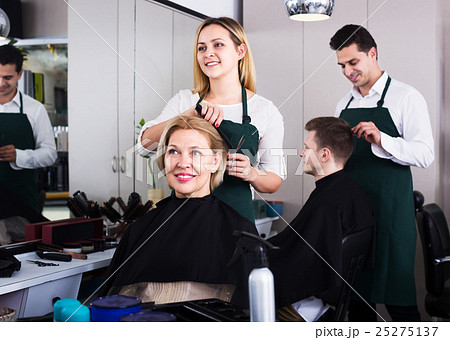 Blonde cuts hair at salon Blonde cuts hair at salon 25275137