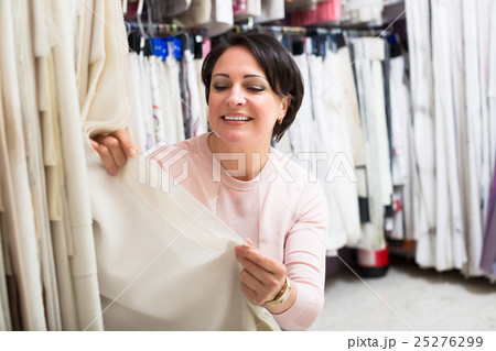 Customer posing near cloth rolls Customer posing near cloth rolls 25276299