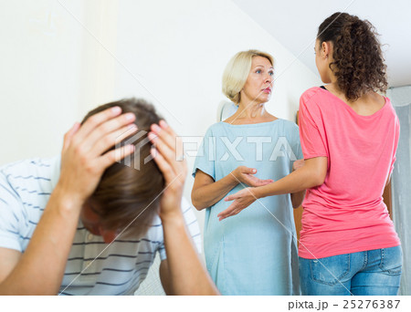 Young man suffering of scandals between family members 25276387