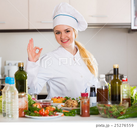 Happy cook preparing vegetable salad with cheese Happy cook preparing vegetable salad with cheese 25276559