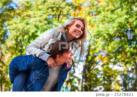 Young couple hugging and flirting in park. Young couple hugging and flirting in park. 25276621