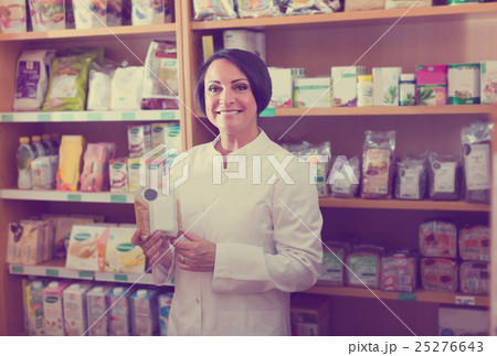 mature woman seller in drugstore . mature woman seller in drugstore . 25276643