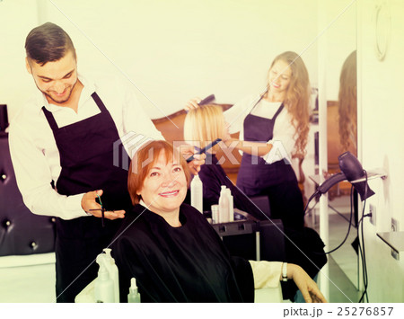 Mature person doing haircut at the salon 25276857