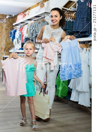 happy mother with daughter in shop 25277131