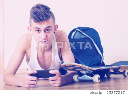 Teenager burying in mobile phone Teenager burying in mobile phone 25277217