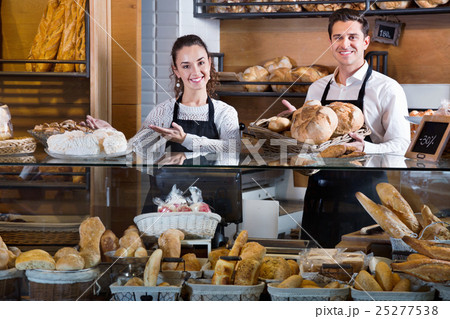 Portrait of charming happy smiling couple at bakery display Portrait of charming happy smiling couple at bakery display 25277538