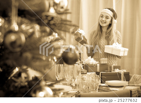 Young woman posing with Christmas gifts Young woman posing with Christmas gifts 25277632
