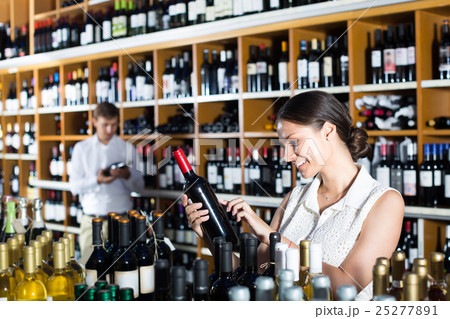 female customer in wine store. female customer in wine store. 25277891