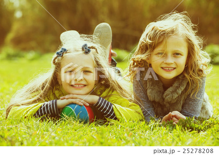 Portrait of two cute girls with ball Portrait of two cute girls with ball 25278208