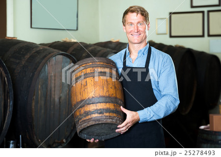 Man carrying wine wood in hands 25278493