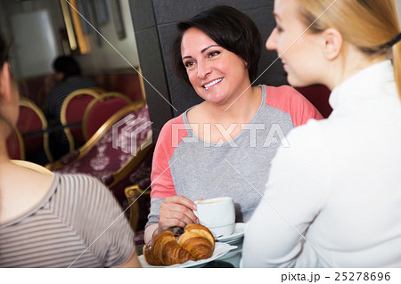 Three woman sitting in cafe Three woman sitting in cafe 25278696