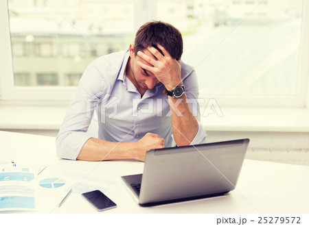 businessman with laptop and papers in office 25279572