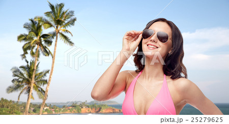 happy woman in sunglasses and bikini on beach happy woman in sunglasses and bikini on beach 25279625