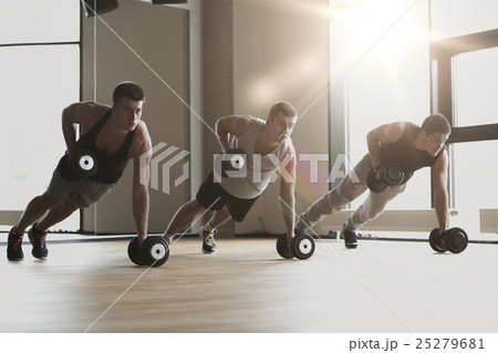 group of men with dumbbells in gym group of men with dumbbells in gym 25279681