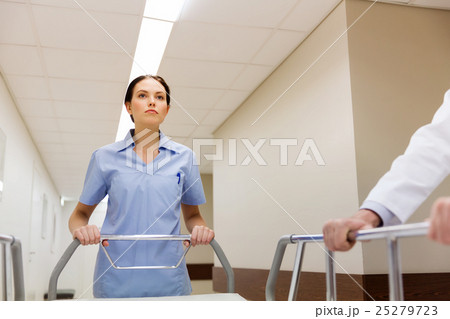 medic carrying hospital gurney at emergency 25279723
