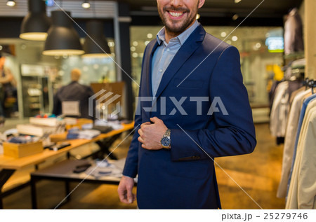 close up of happy man in suit at clothing store close up of happy man in suit at clothing store 25279746