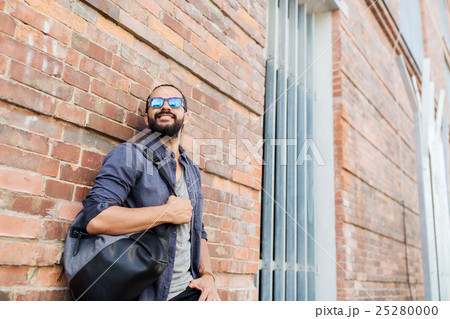 happy man with backpack standing at city street happy man with backpack standing at city street 25280000