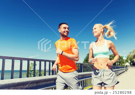 smiling couple running at summer seaside smiling couple running at summer seaside 25280298