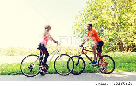 happy couple riding bicycle outdoors happy couple riding bicycle outdoors 25280326