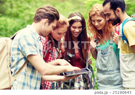 happy friends with backpacks and tablet pc hiking 25280645