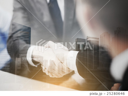 two businessmen shaking hands in office 25280646