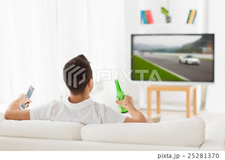 man watching tv and drinking beer at home man watching tv and drinking beer at home 25281370
