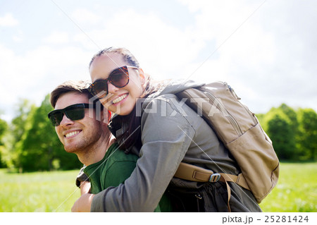 happy couple with backpacks having fun outdoors 25281424